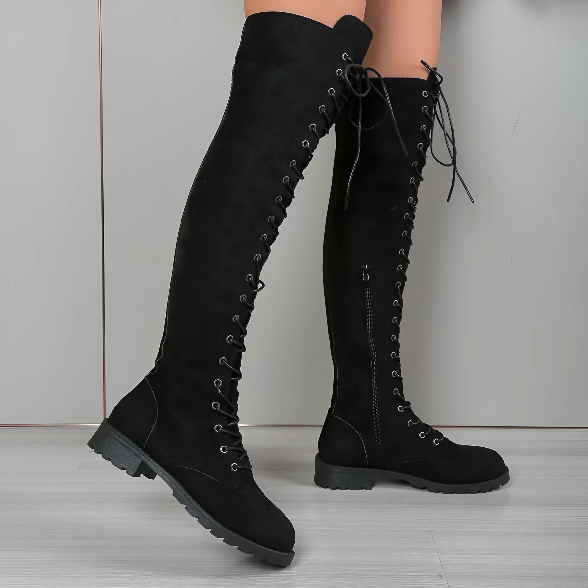 Flat heel round toe lace-up over the knee boots in black, shown with keep warm function and stitching detail.