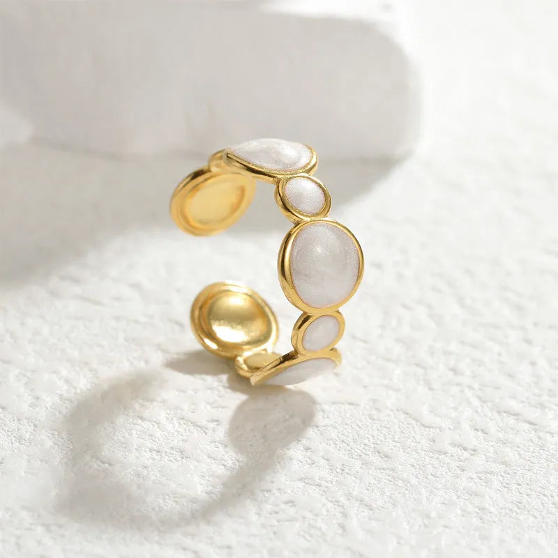 Adjustable geometric ring in stainless steel with electroplated finish, showing open design for flexible sizing