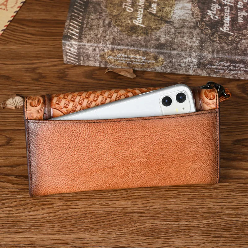 Women's brown tri-fold leather wallet with embossed floral pattern showing open compartments