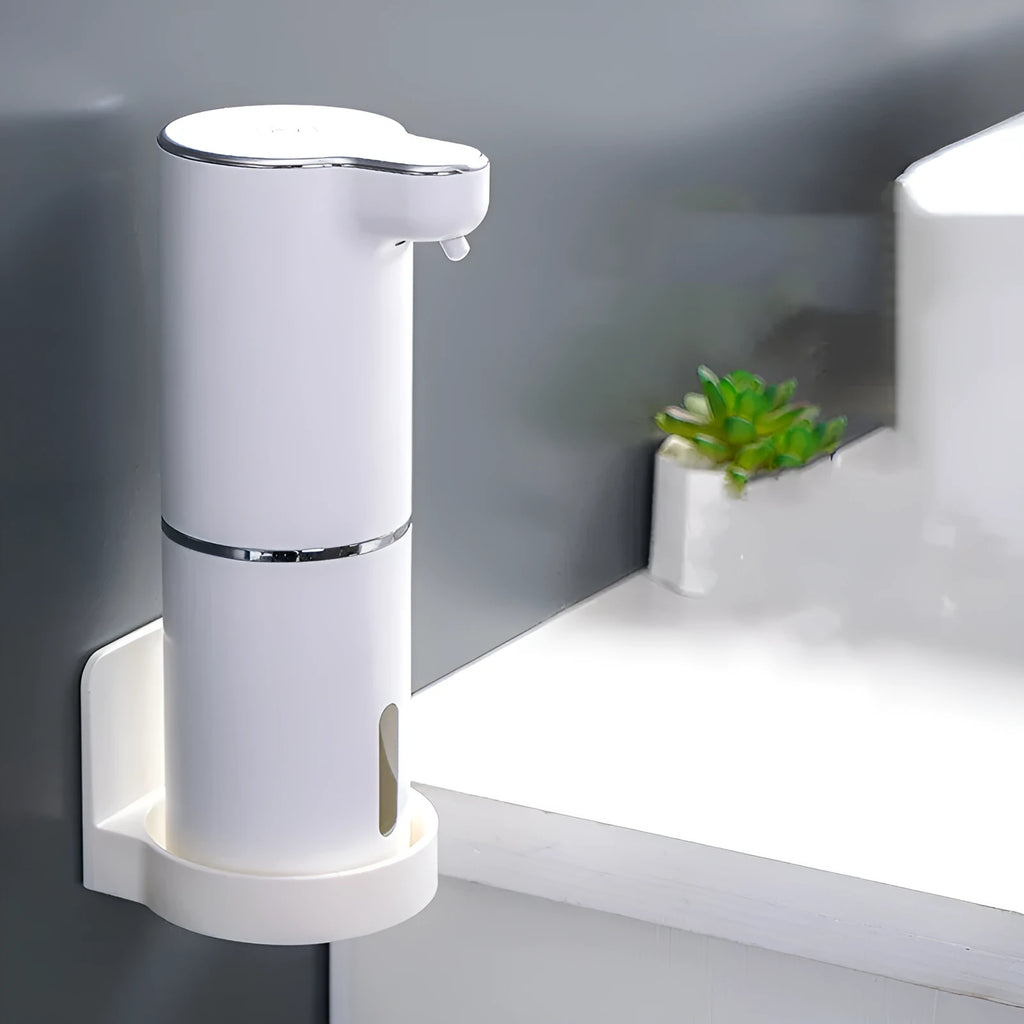 White ABS automatic sensor soap dispenser on countertop with USB cable, dispensing foam hand sanitiser.