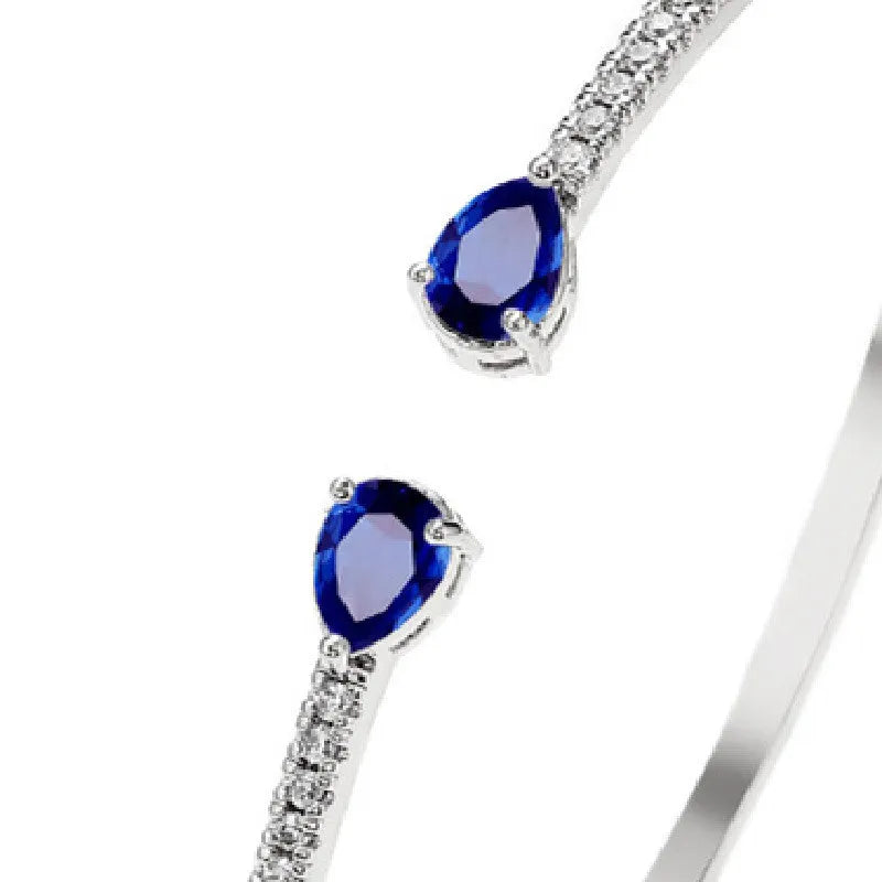 Copper bracelet with multi-zircon inlay in simple style, shown in white and blue colour options.