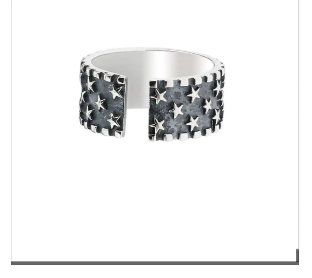 Adjustable sterling silver ring with a geometric five-pointed star pattern on a plain background.