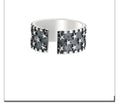 Adjustable sterling silver ring with a geometric five-pointed star pattern on a plain background.