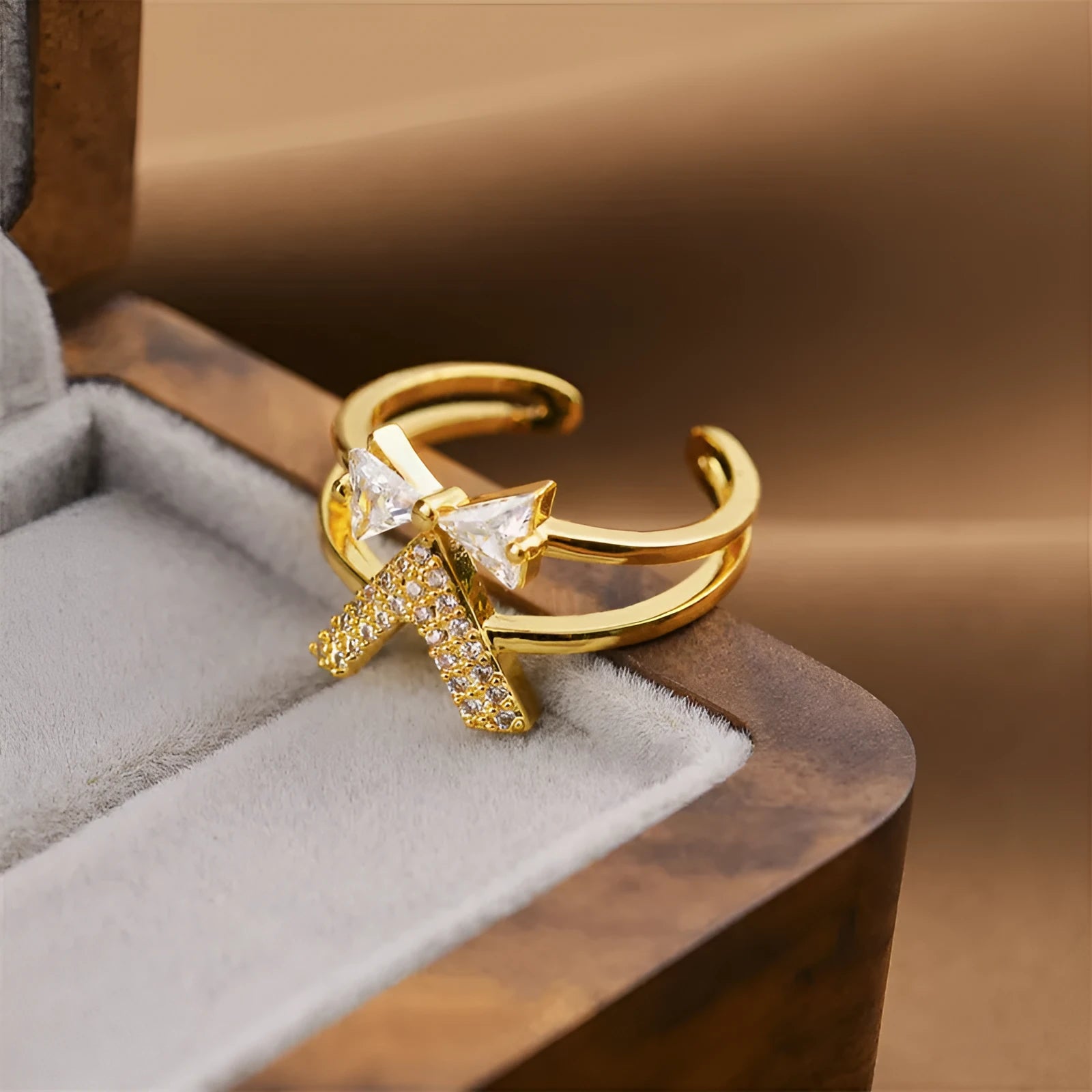 Gold tone geometric open back fashion ring on a hand, showing its adjustable design.