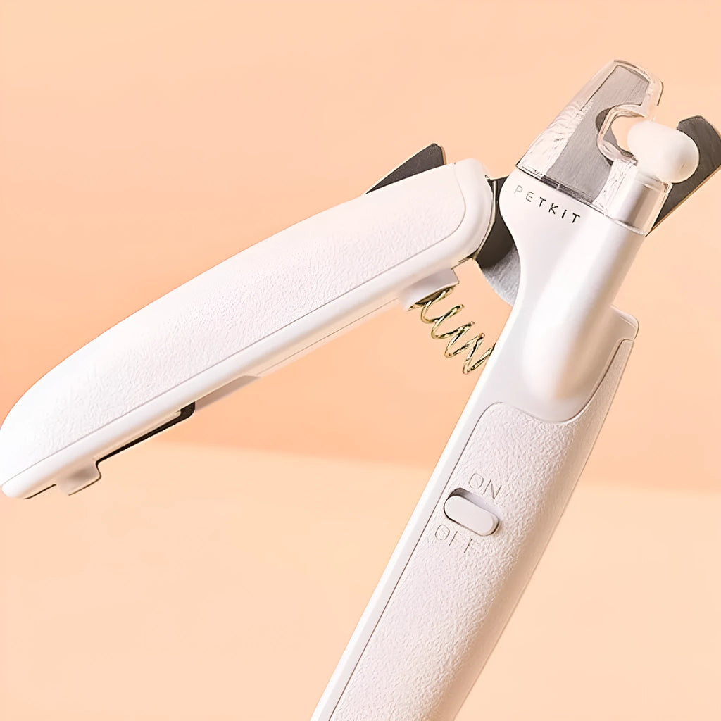 White pet nail clippers with LED light and a transparent anti-splash guard, shown with a nail file.