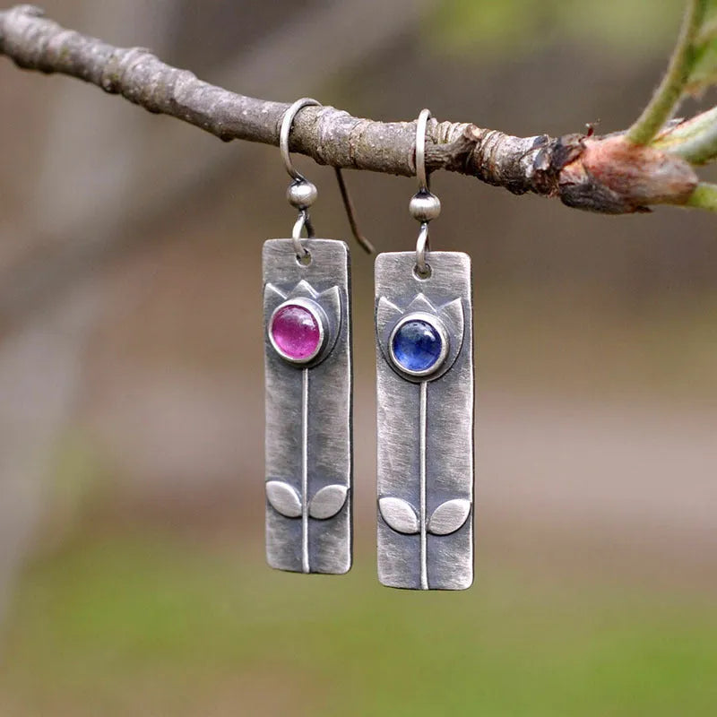 Geometric antique finish earrings with red sapphire detailing and electroplated metal construction