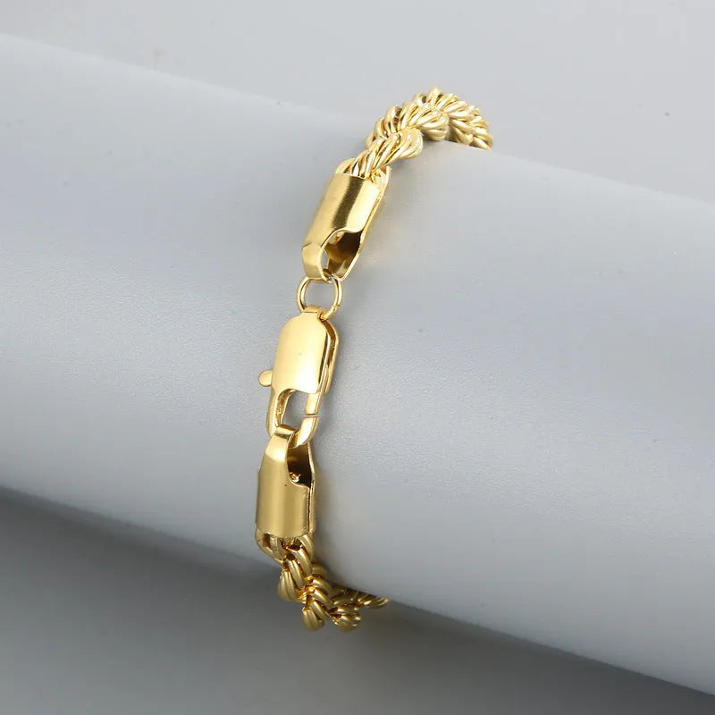 Gold double colour twist chain titanium steel bracelet with geometric design on white background