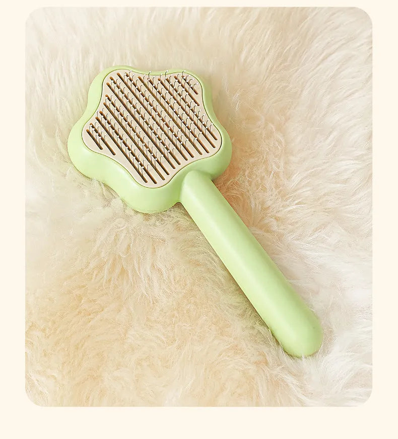 Large green self-cleaning cat comb magic wand with stainless steel needle teeth for pet grooming.