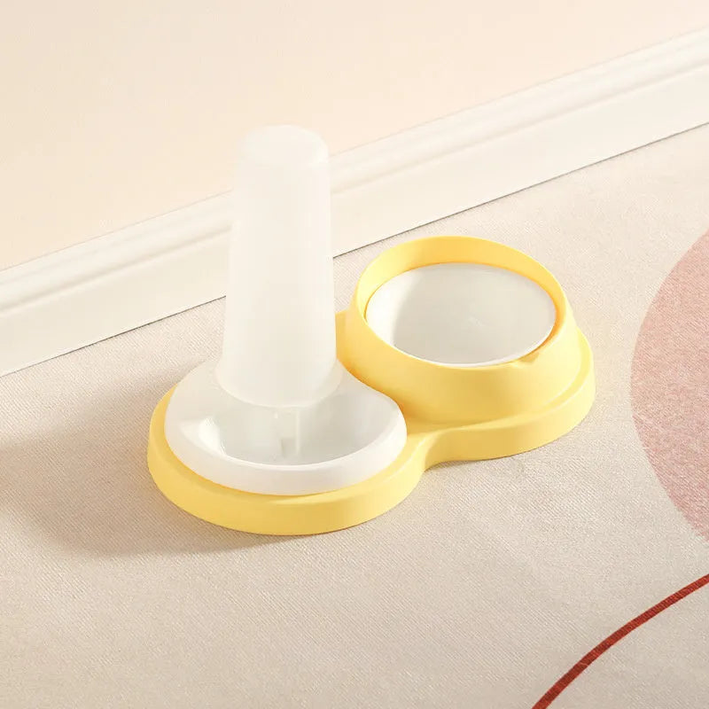 Grey and yellow pet dual feeding bowl with ceramic dish and stainless steel water dispenser on non-slip base