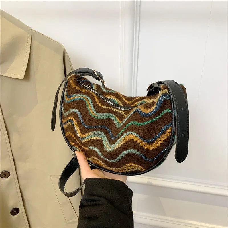 Straw woven crossbody bag showing woven texture and interior phone compartment