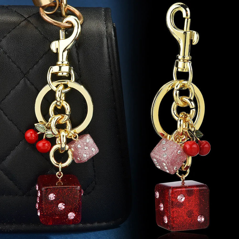 Square metal dice keychain pendant with cherry two-tone electroplated finish on a keyring