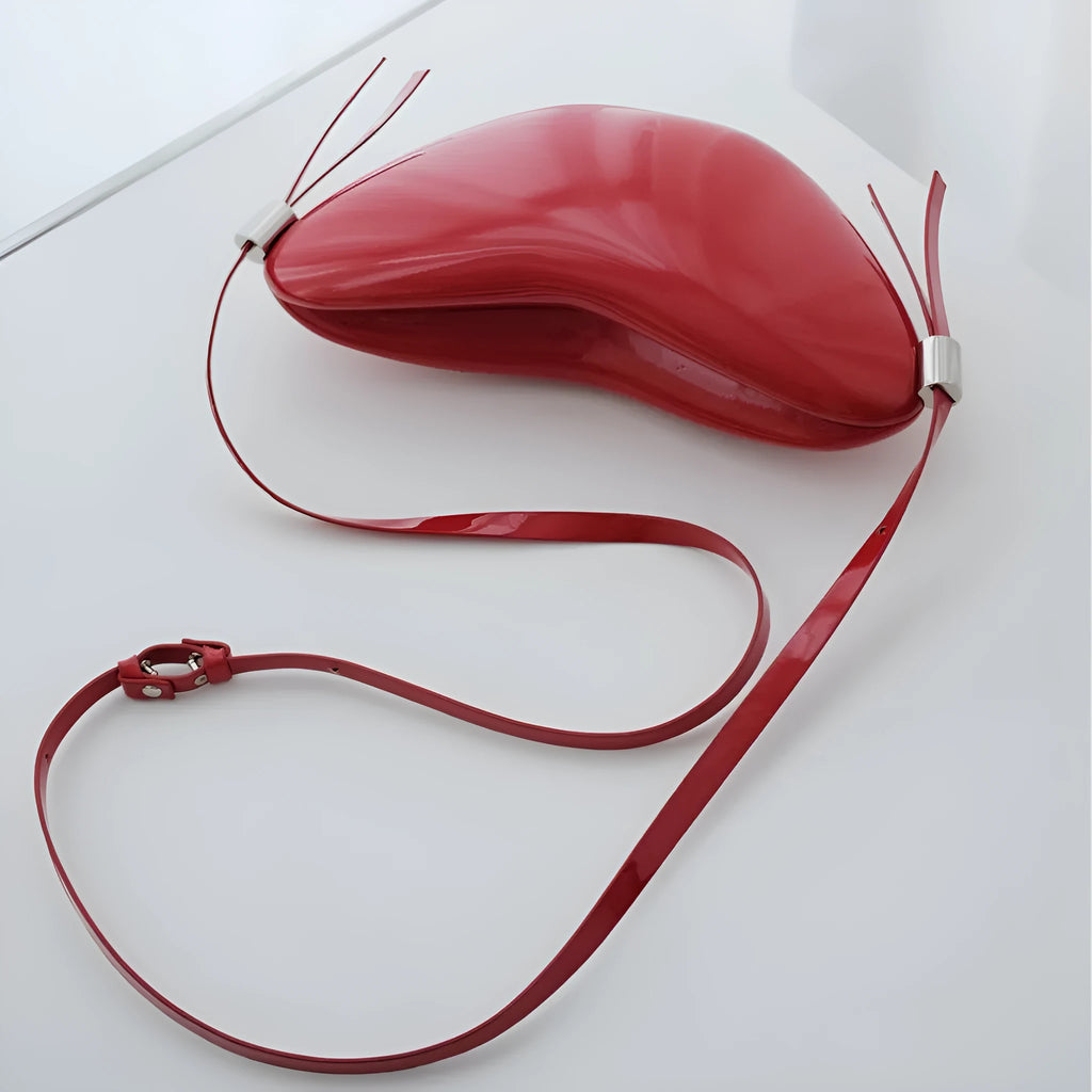 Red heart-shaped crossbody bag in PU material with single shoulder strap and exterior pocket