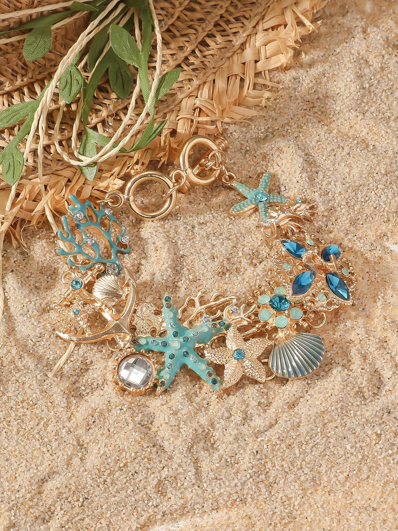 Women's alloy rhinestone bracelet with a nautical boat anchor and starfish design in blue coral colour.