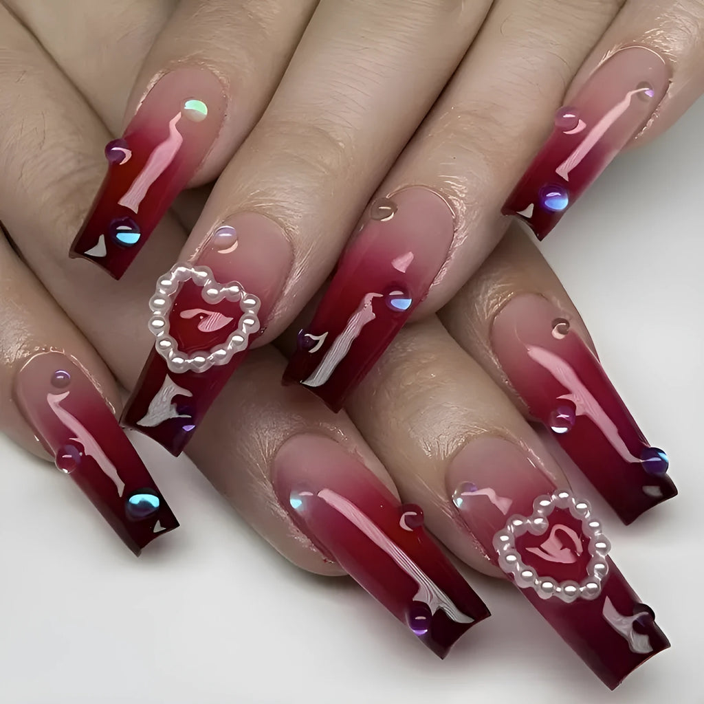 Wine red gradient fake nail tips with plaid pattern in long ballet style displayed with jelly glue applicator