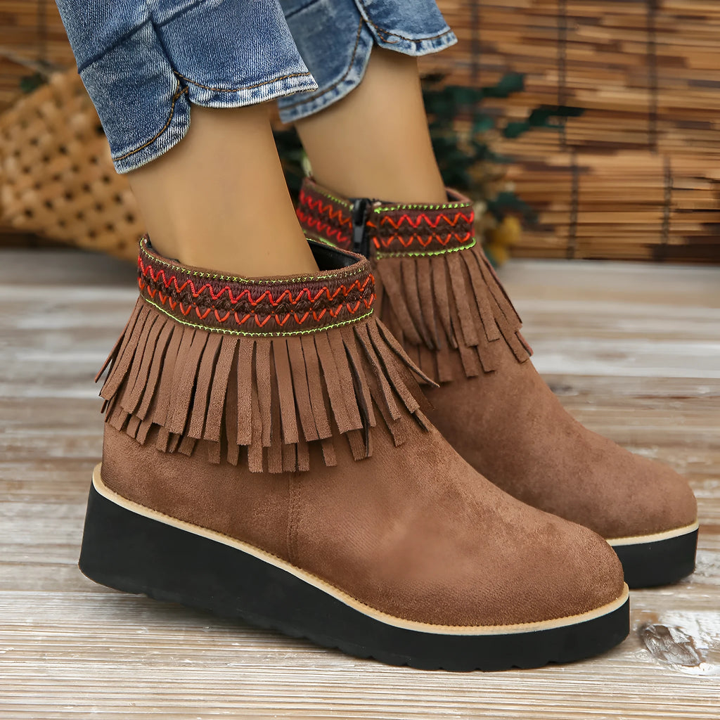 Women's dark brown suede wedge bootie with side zip, tassel detail, and thick rubber sole