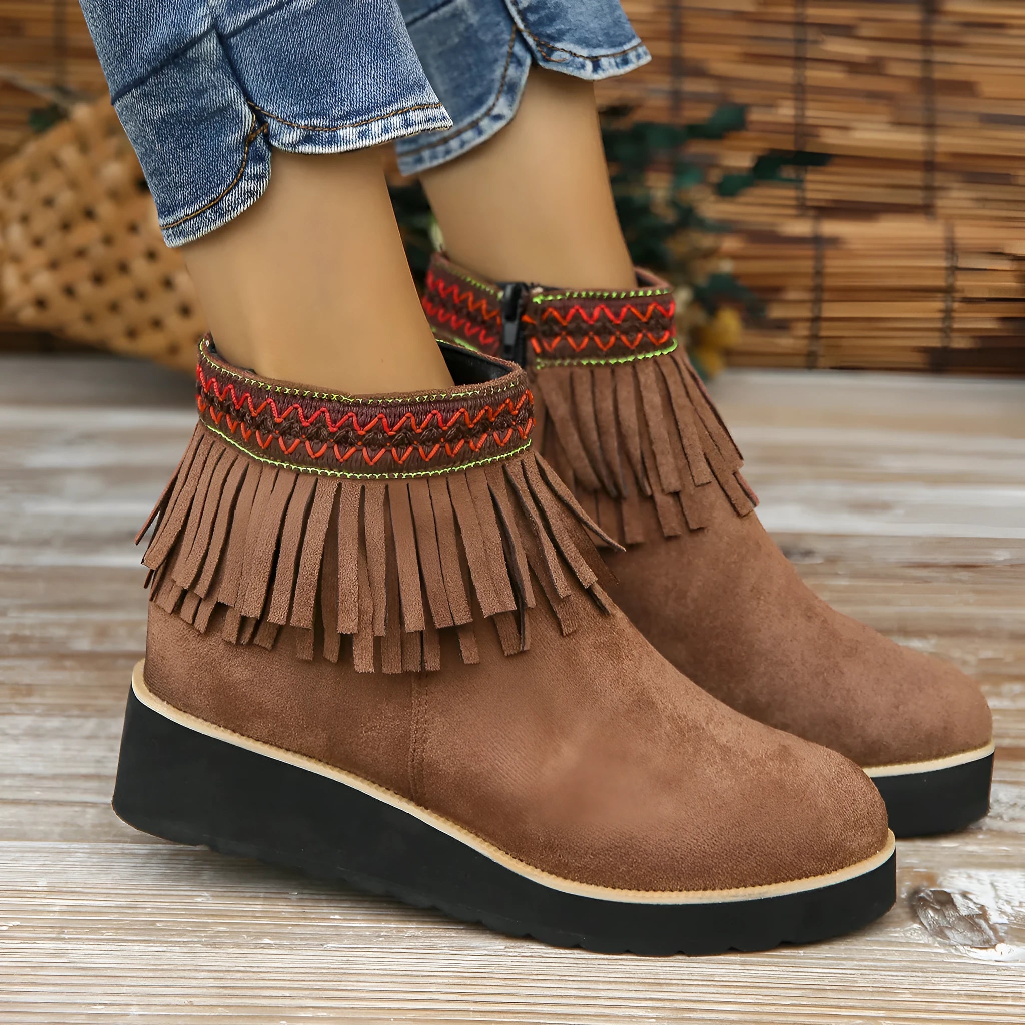 Women's dark brown suede wedge bootie with side zip, tassel detail, and thick rubber sole
