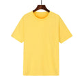 A man's loose-fitting black cotton t-shirt with short sleeves laid flat.