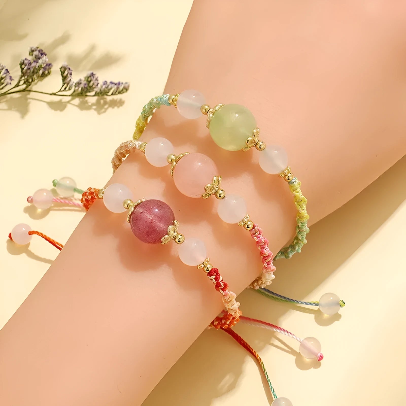 Hand-woven white agate and prehnite couple bracelet with 12mm diamond-shaped beads and electroplated finish on woman's wrist
