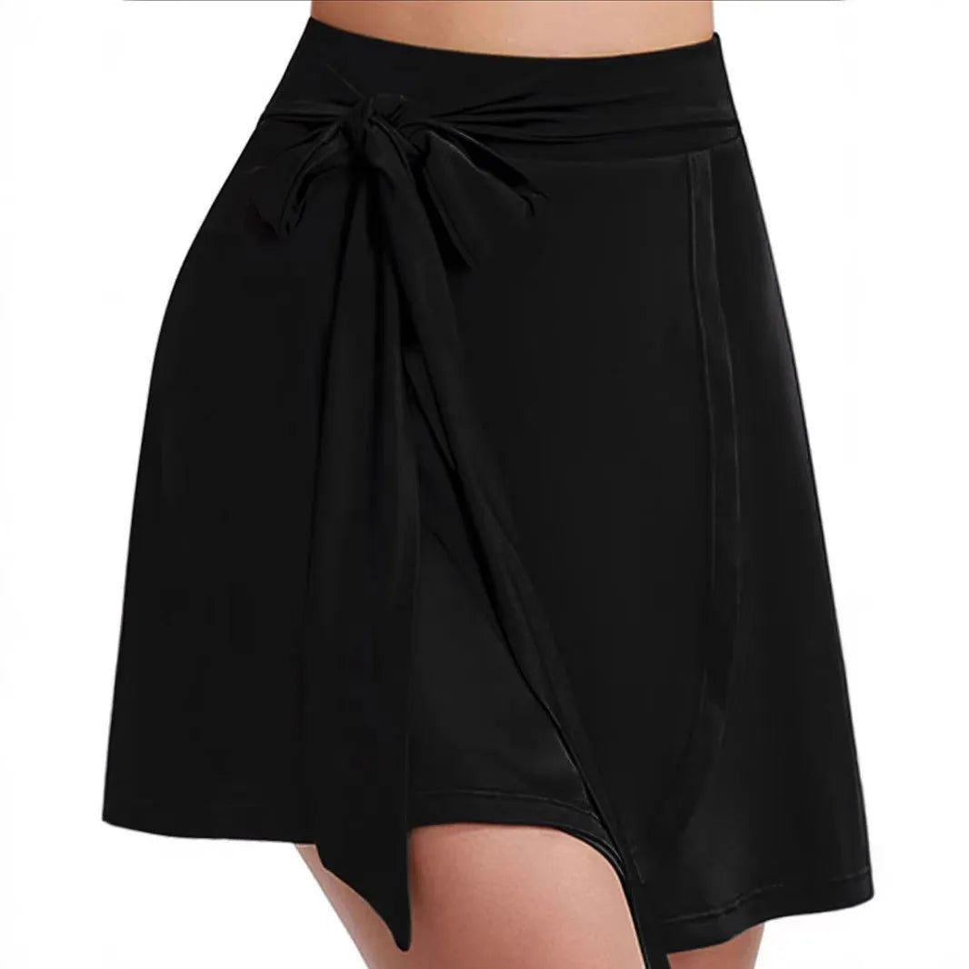 Black unisex high-waist sports skirt with built-in shorts and a shoulder strap detail.