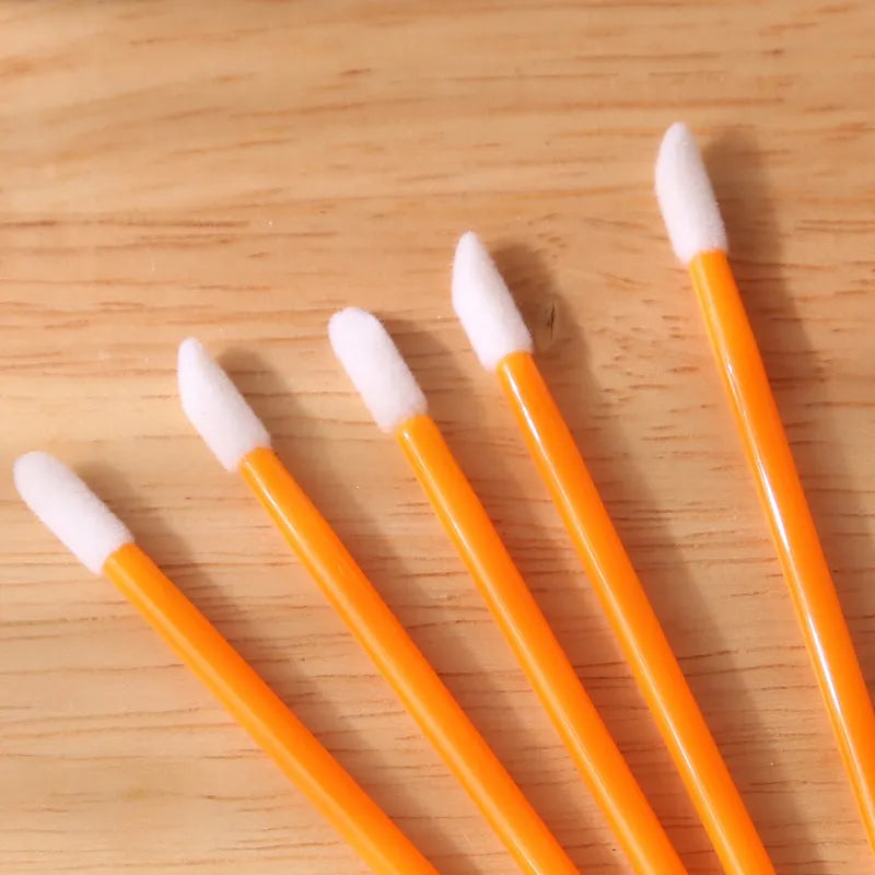 Disposable lip brushes with coloured handles and flocked brush heads for lip makeup application
