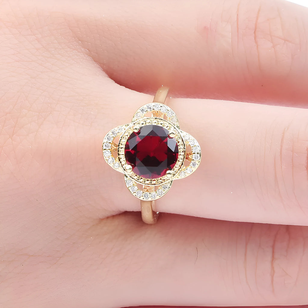 Copper zircon ring with a fruit-shaped design on a finger.