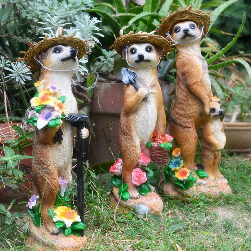Three resin mongoose garden ornaments with straw hats, including figures holding rake and shovel tools
