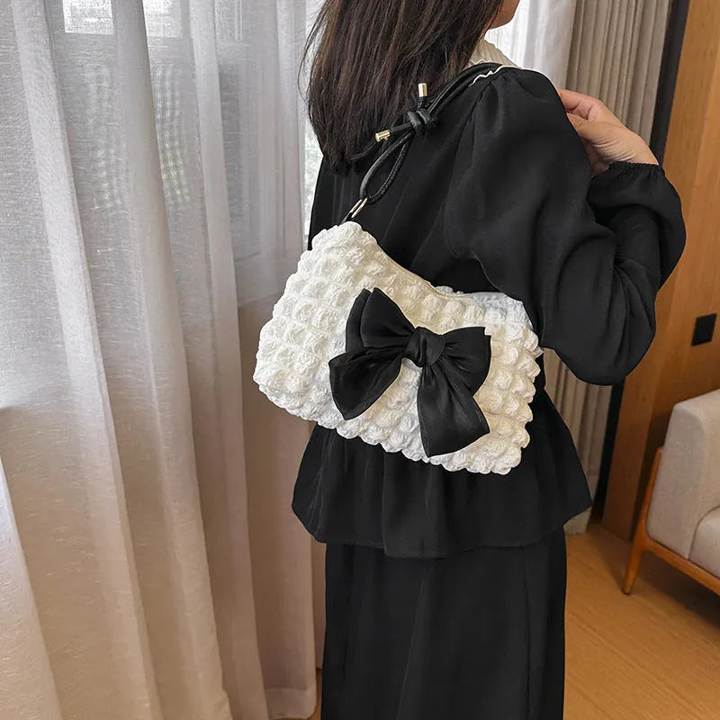 Women's canvas shoulder handbag with sandwich pocket design in black colour showing horizontal square shape