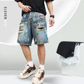 Blue men's denim shorts with ripped knees and graffiti detailing, showing straight leg cut and zipper fly.