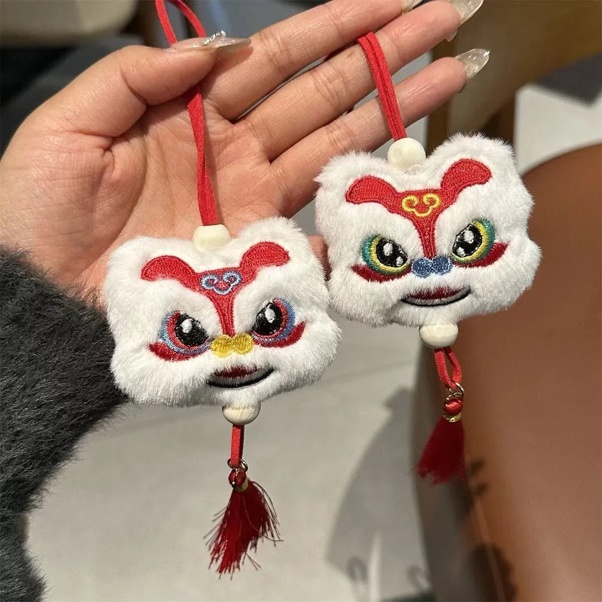 Blue and yellow handmade plush lion keychain with star stones and tassels in Chinese cartoon style