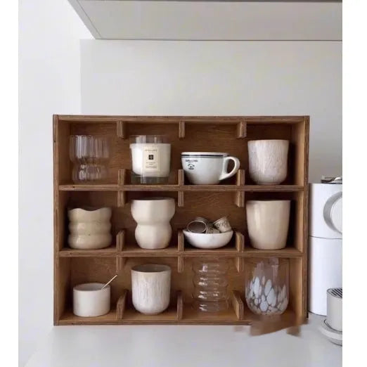 Square birch wood cup storage rack with multiple grid compartments for organising drinkware.