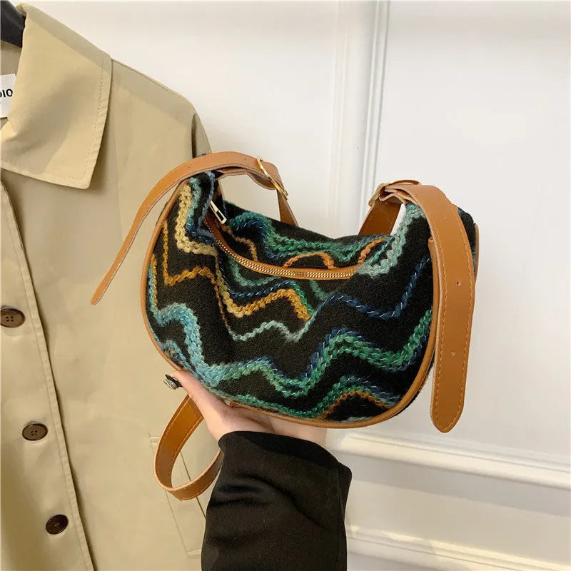 Straw woven crossbody bag showing woven texture and interior phone compartment