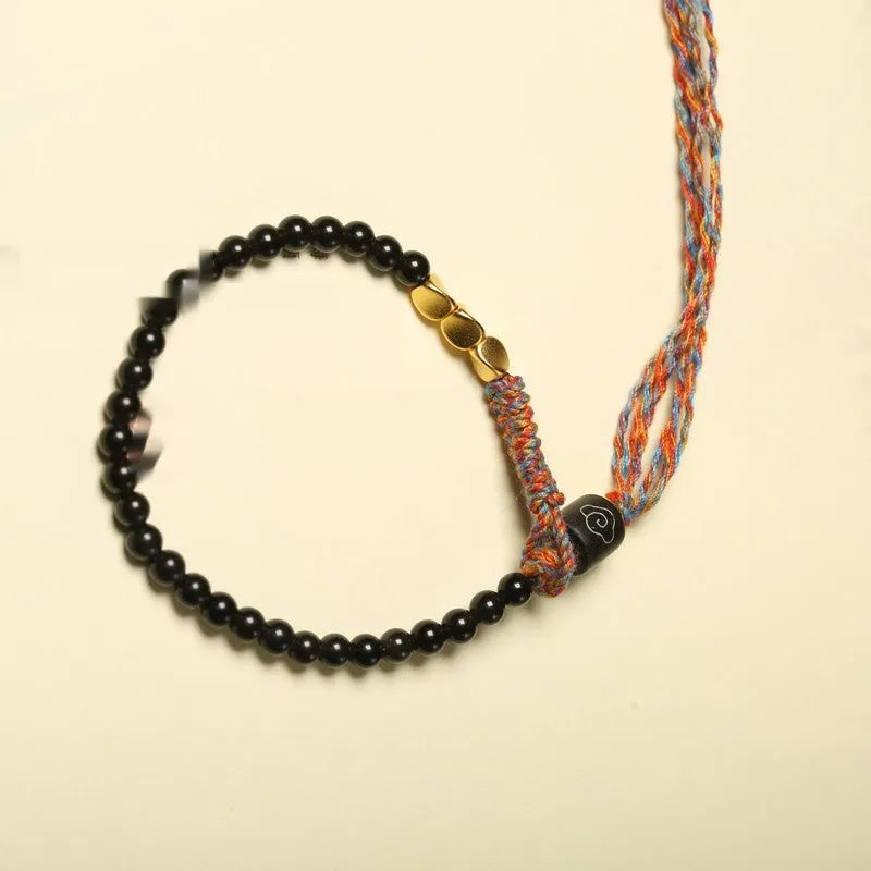 Hand-woven obsidian carrying strap bracelet showing textured surface and 4mm width