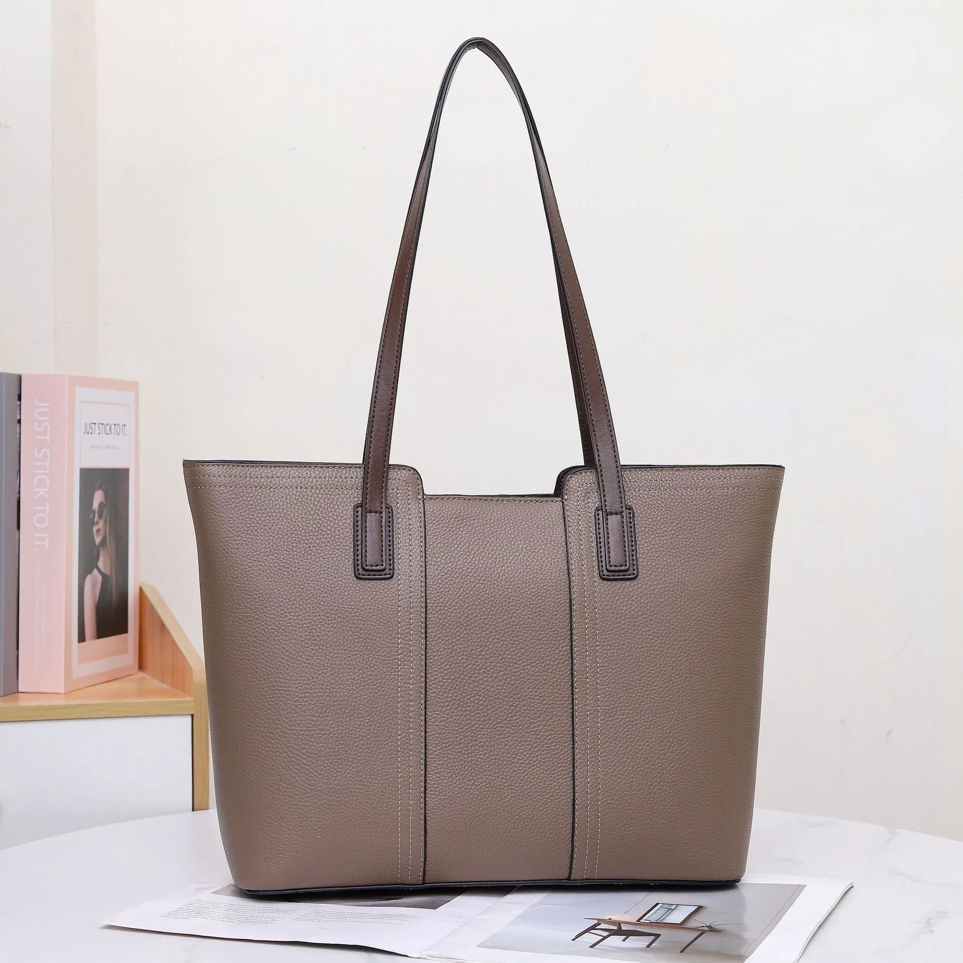 Women's genuine leather shoulder bag in khaki colour showing box-type design and organised interior compartments