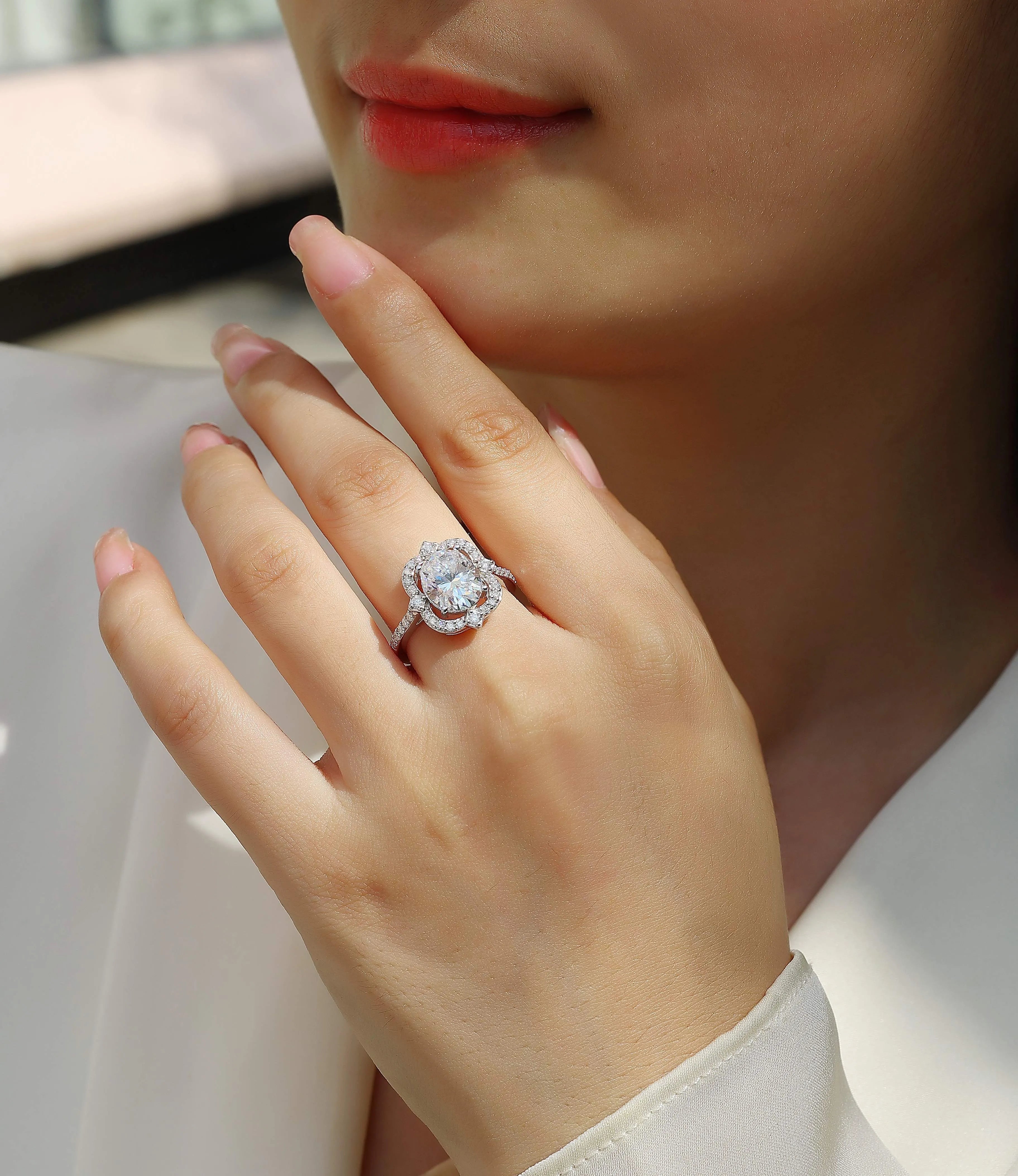 Camellia egg-shaped moissanite wedding ring set with S925 silver and platinum plating, showing centre stone and band