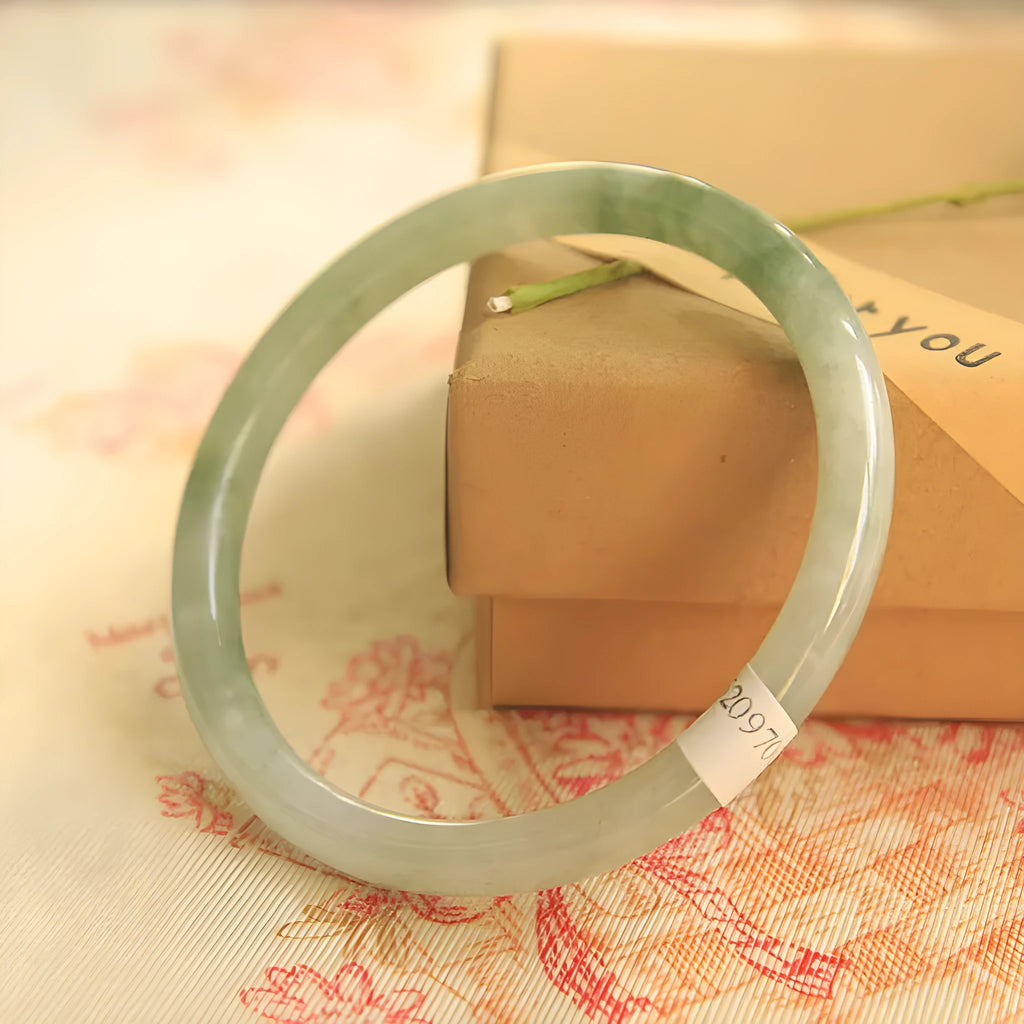 Green jade waxy geometric Chinese style bracelet showing 10mm width on wrist.