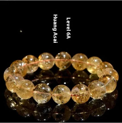Natural yellow Asestelle citrine bracelet with hand-ground geometry beads on a wrist.