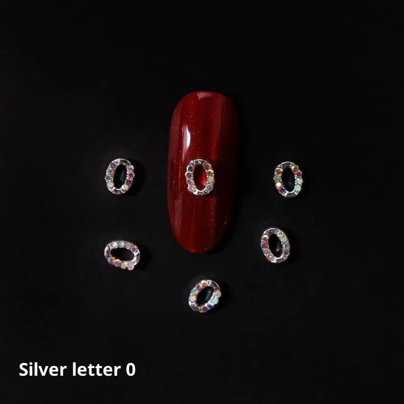 Gold alloy letter A nail ornament charm with crystal detail on a square chain base