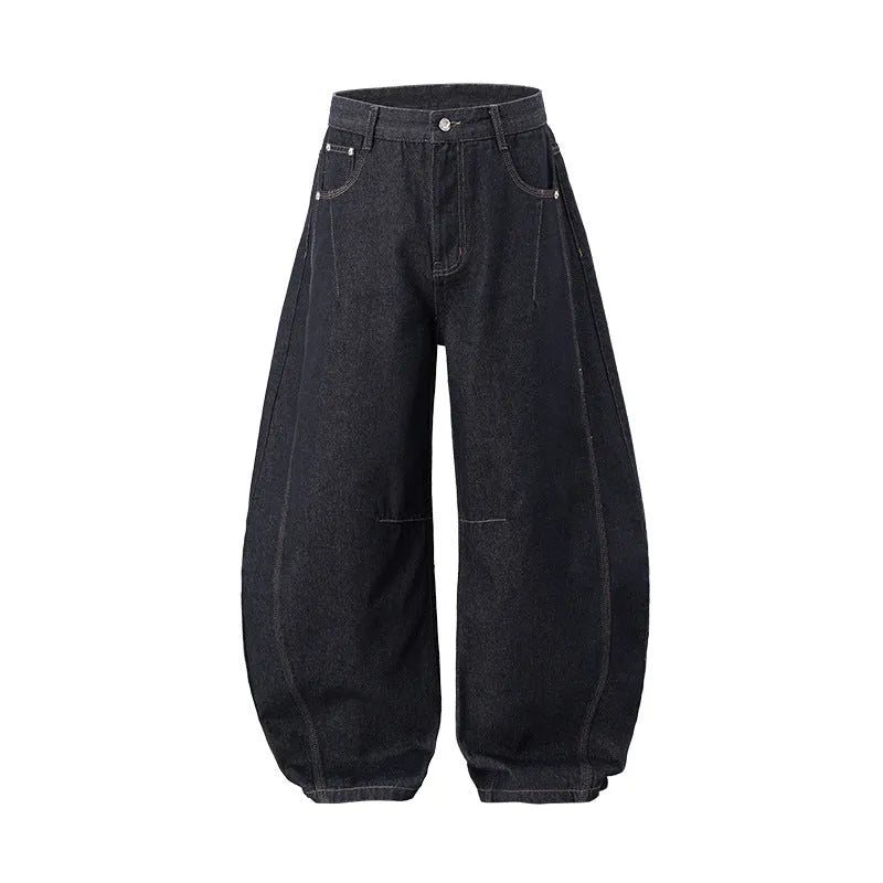 Men's original cow colour wide leg denim trousers laid flat showing mid-waist and relaxed leg cut