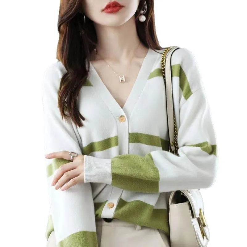 Women's black and white striped V-neck knitted cardigan with 3D pattern on a hanger.
