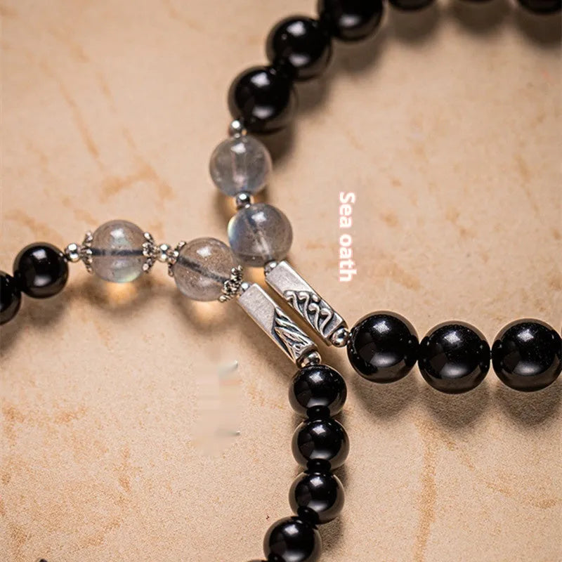 Obsidian couple bracelet DIY set with 8mm and 10mm Buddha beads on adjustable string.