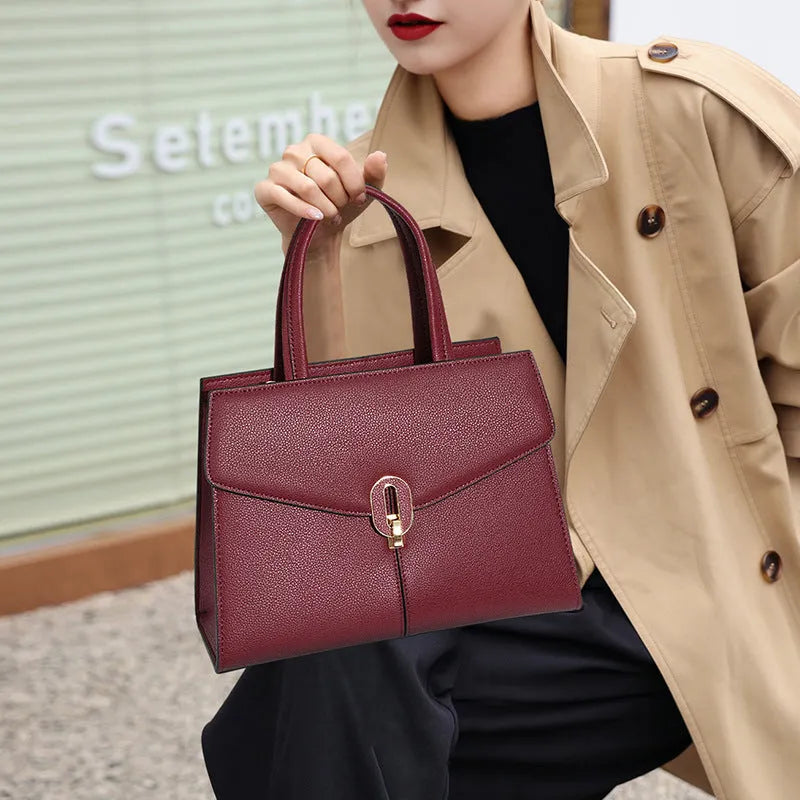 Genuine leather box handbag with litchi pattern and lock detail in brown