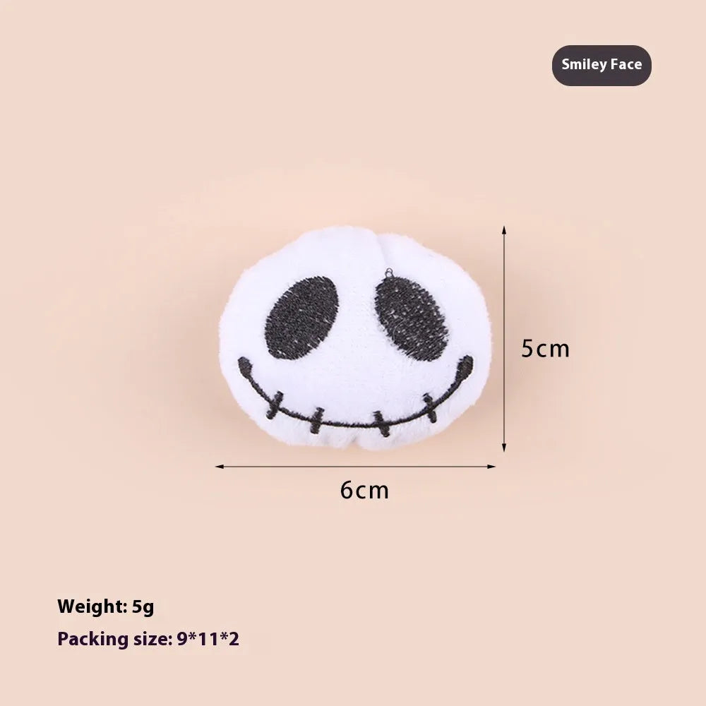 Plush cat teaser toy with three interchangeable heads: eyes, candy, and skull designs