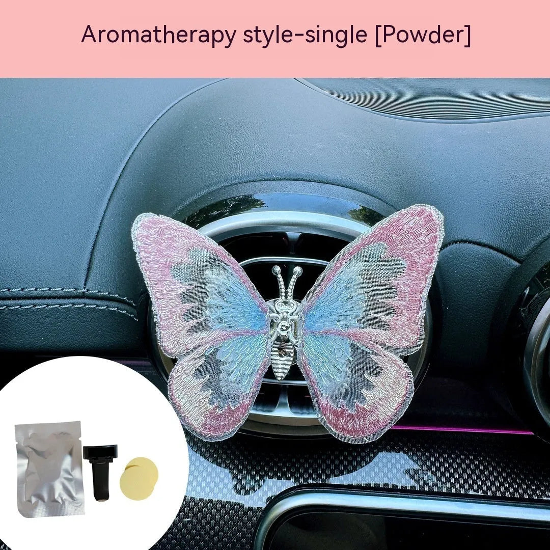 Moving embroidery butterfly decoration on car centre console air vent in pink fabric