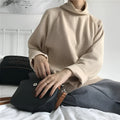 Women's loose-fitting long sleeve top with a half-high collar in a solid colour.