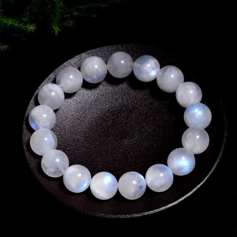 Natural blue moonlight round bead moonstone bracelet on wrist showing polished gemstone beads