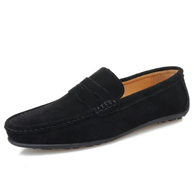 Men's solid colour suede loafers with round toe and rubber sole on a neutral background.