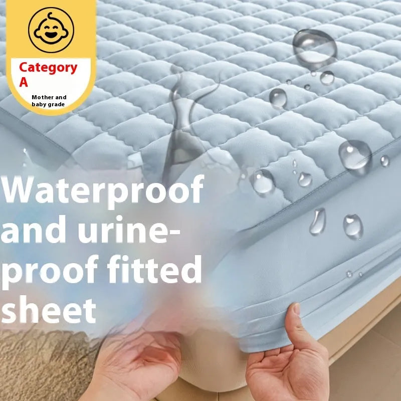 Blue washed cotton fitted sheet with quilted pattern on a bed, showcasing its waterproof protection feature.