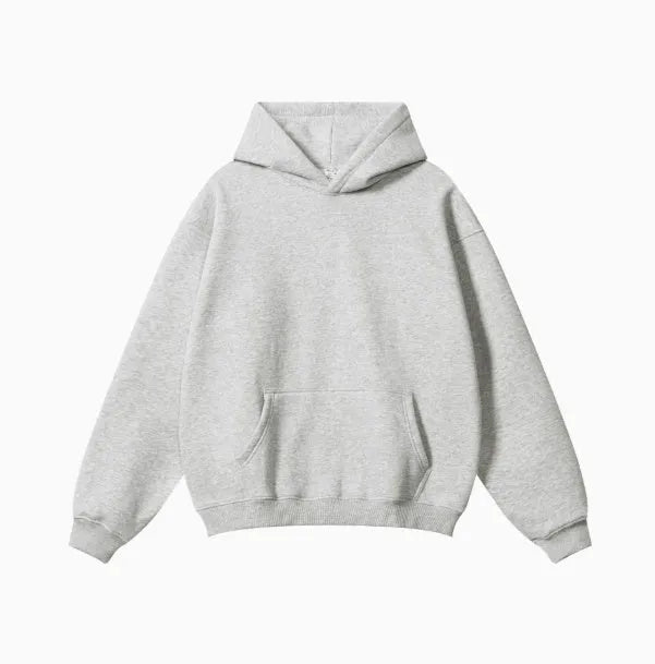 Man wearing a loose-fit grey terry cotton hooded sweater with drop-shoulder sleeves.