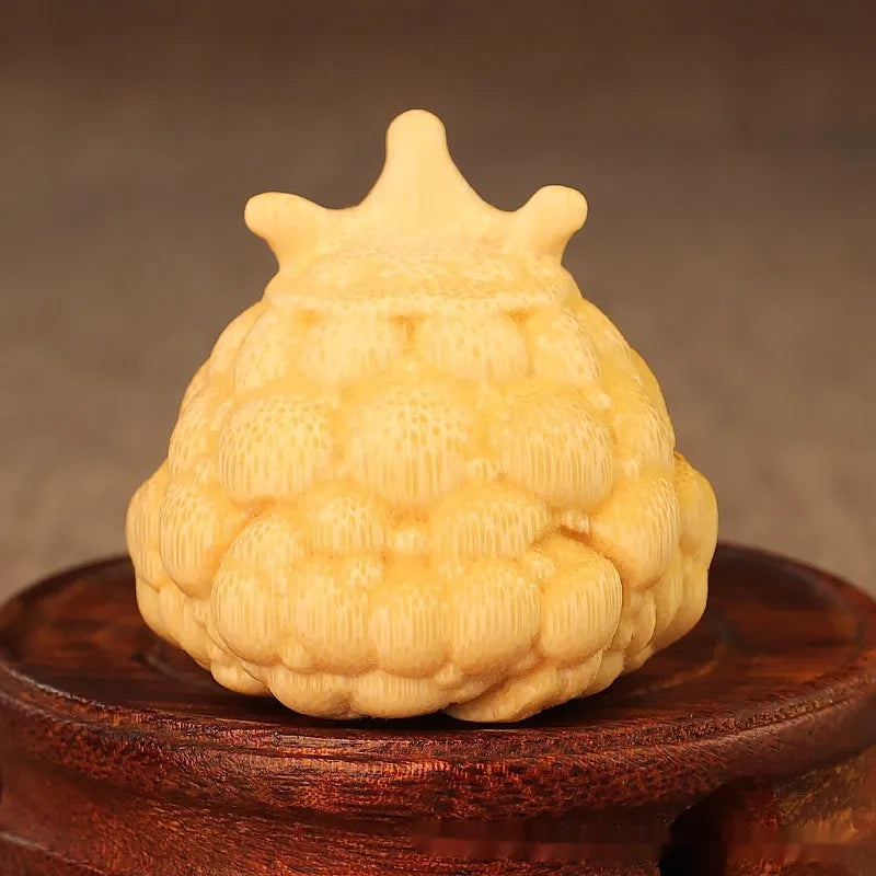Solid bamboo carving of a cute Crown Princess Toad ornament, showing live eye detail.