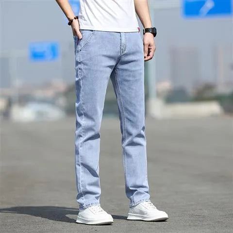 Men's smoky gray straight tube jeans with low waist and zipper fly closure